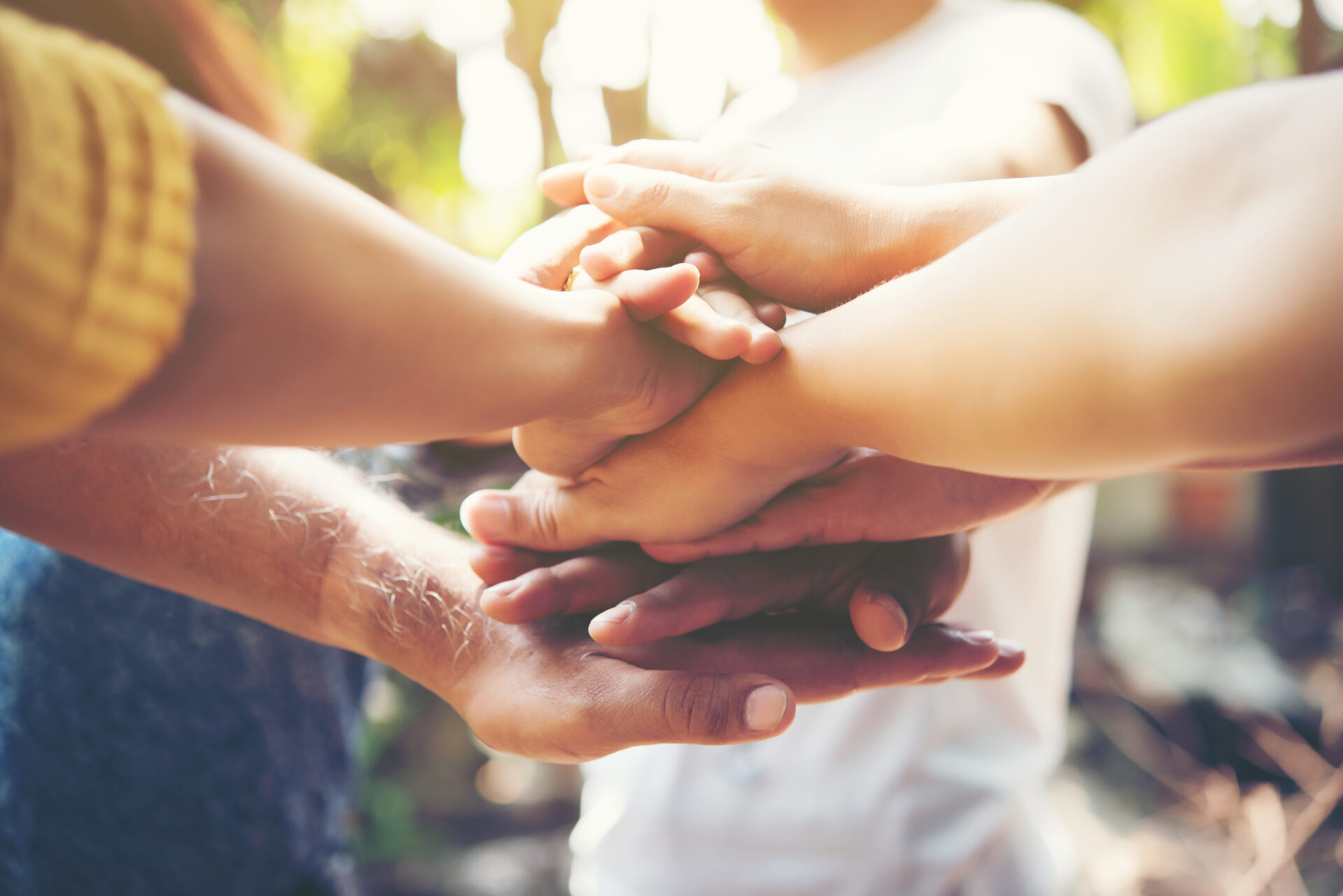 Close up of young people putting their hands together. Team with Close up of young people putting their hands together. Team with stack of hands showing unity and teamwork.